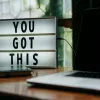 An image saying You Got This on a table next to a laptop